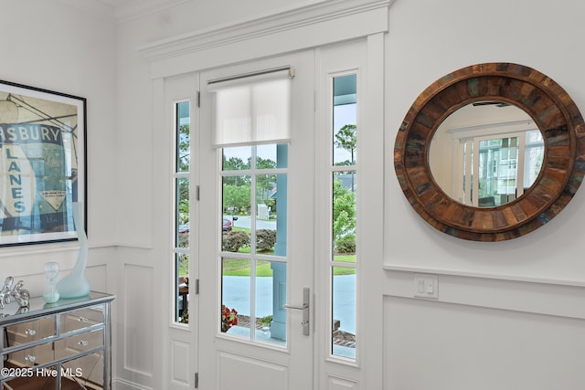 3752 Glenmere Ln, Southport, NC 28461 - doorway to outside featuring healthy amount of natural light, crown molding, and a decorative wall