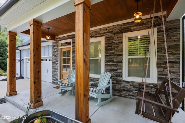 708 Cordgrass Rd, Hampstead, NC 28443 - view of patio / terrace with covered porch, concrete driveway, and a garage