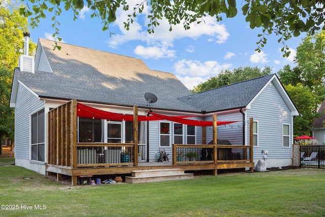 708 Cordgrass Rd, Hampstead, NC 28443 - rear view of house with a wooden deck, a yard, a chimney, and roof with shingles