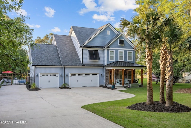 708 Cordgrass Rd, Hampstead, NC 28443 - craftsman house featuring a porch, driveway, roof with shingles, a garage, and a standing seam roof