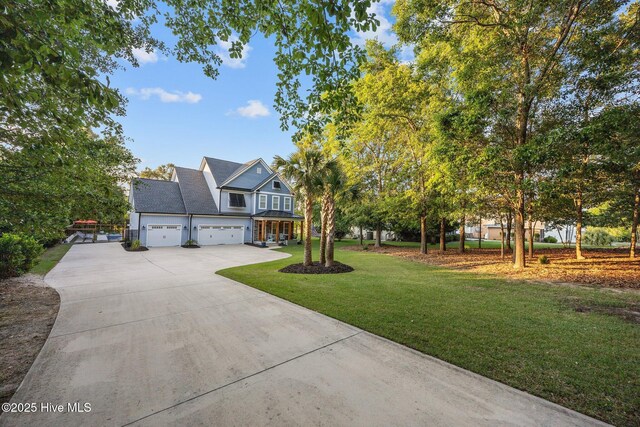 708 Cordgrass Rd, Hampstead, NC 28443 - view of front of house featuring driveway, a front yard, and a garage