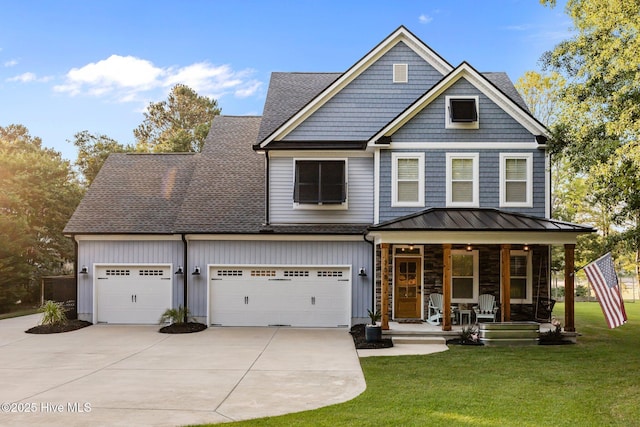 708 Cordgrass Rd, Hampstead, NC 28443 - view of front of property featuring a porch, concrete driveway, a front lawn, and a standing seam roof