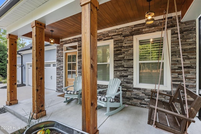 708 Cordgrass Rd, Hampstead, NC 28443 - view of patio / terrace featuring covered porch, driveway, and an attached garage