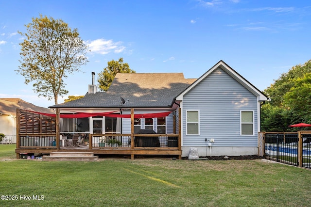 708 Cordgrass Rd, Hampstead, NC 28443 - back of property featuring a deck, a chimney, and a shingled roof