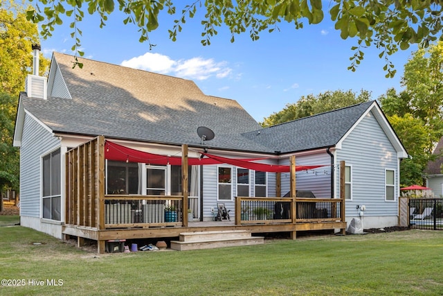 708 Cordgrass Rd, Hampstead, NC 28443 - rear view of house featuring a wooden deck, a lawn, a chimney, and a shingled roof