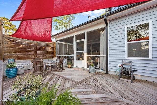 708 Cordgrass Rd, Hampstead, NC 28443 - wooden deck with a sunroom, an outdoor living space, and fence