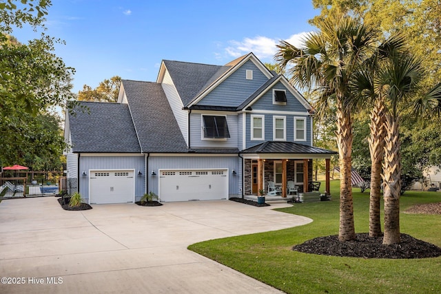 708 Cordgrass Rd, Hampstead, NC 28443 - view of front of property with a porch, driveway, roof with shingles, and an attached garage