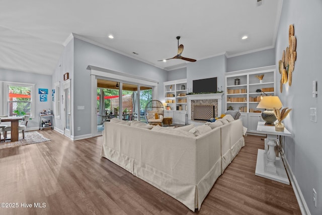 708 Cordgrass Rd, Hampstead, NC 28443 - living room with a ceiling fan, baseboards, ornamental molding, wood finished floors, and a fireplace