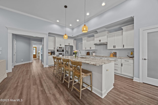 708 Cordgrass Rd, Hampstead, NC 28443 - kitchen with appliances with stainless steel finishes, dark wood-type flooring, under cabinet range hood, a sink, and recessed lighting