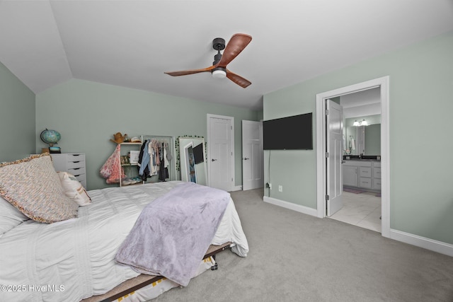 708 Cordgrass Rd, Hampstead, NC 28443 - bedroom featuring light carpet, baseboards, connected bathroom, ceiling fan, and vaulted ceiling