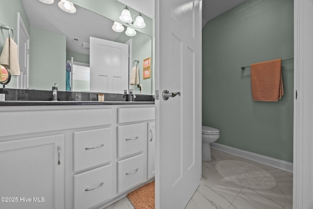 708 Cordgrass Rd, Hampstead, NC 28443 - full bathroom featuring marble look tiles, toilet, double vanity, and baseboards