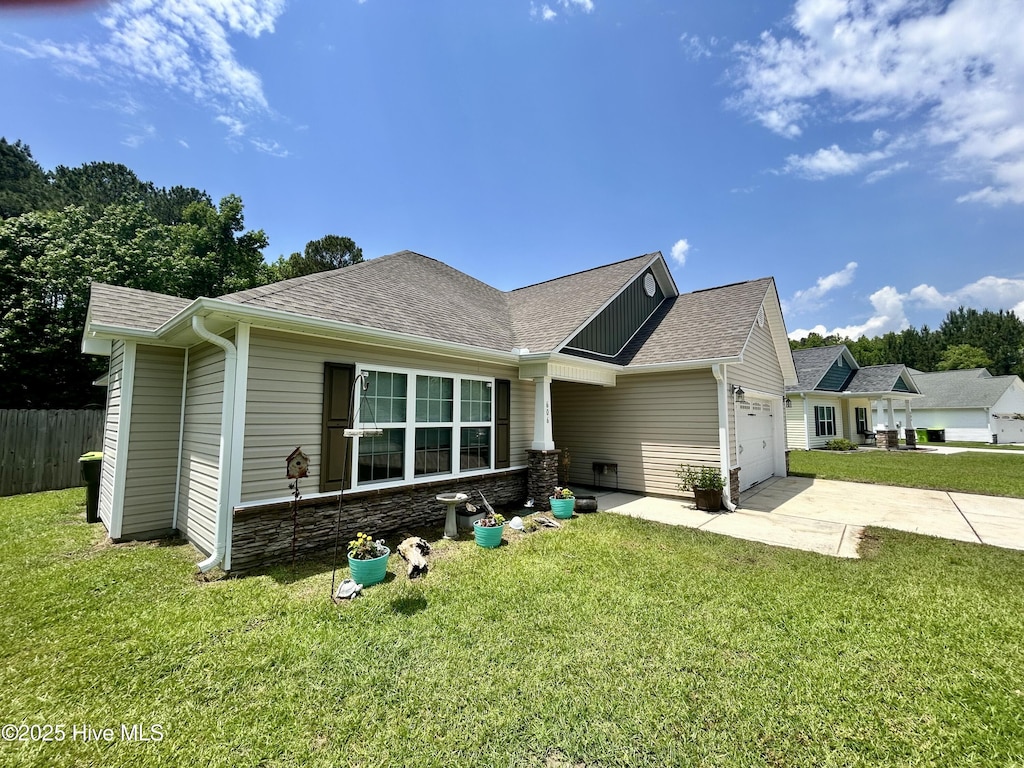 view of front of property with concrete driveway, an attached garage, a shingled roof, and stone siding