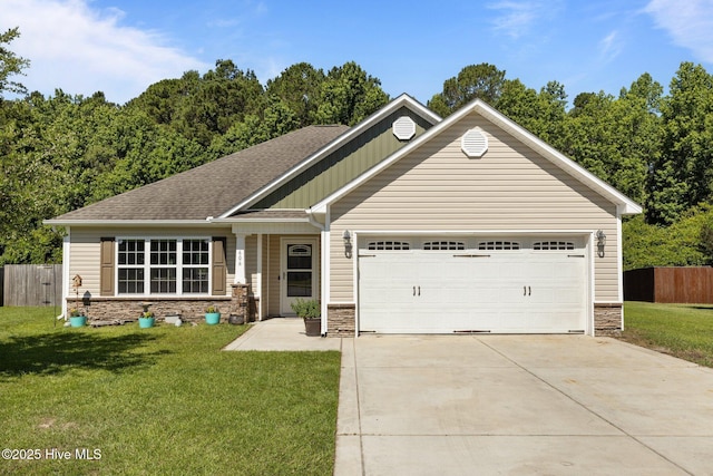 606 Spoleto Ct, Swansboro, NC 28584 - view of front of property featuring stone siding, driveway, a garage, and roof with shingles
