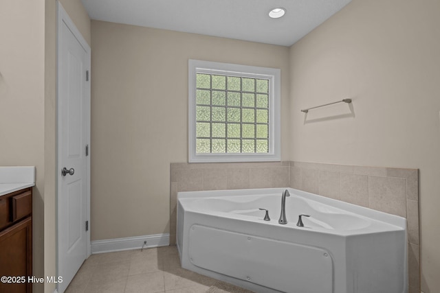 606 Spoleto Ct, Swansboro, NC 28584 - bathroom featuring a garden tub, vanity, tile patterned flooring, and baseboards