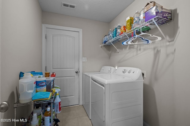 606 Spoleto Ct, Swansboro, NC 28584 - laundry area featuring independent washer and dryer, light tile patterned floors, and a textured ceiling