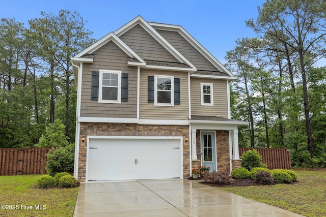 craftsman-style home with stone siding, concrete driveway, a garage, and fence