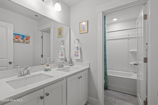 full bathroom with double vanity, baseboards, and shower / tub combo with curtain