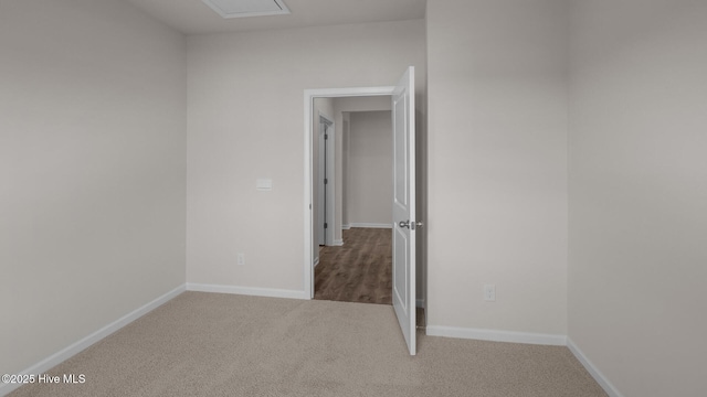 empty room featuring carpet flooring and baseboards