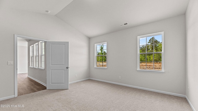 unfurnished bedroom with carpet floors, vaulted ceiling, and baseboards