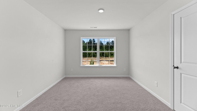 carpeted empty room with baseboards