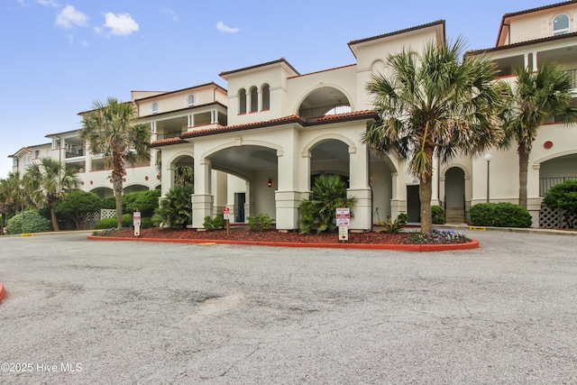 view of building exterior featuring uncovered parking