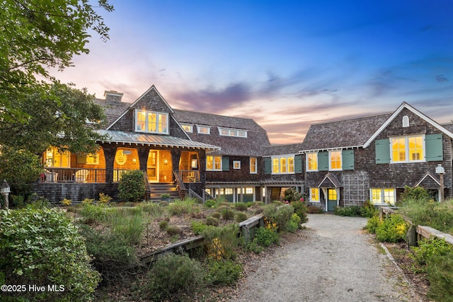 21 Sea Gull Trl, Bald Head Island, NC 28461 - shingle-style home with a standing seam roof, a chimney, metal roof, a porch, and driveway