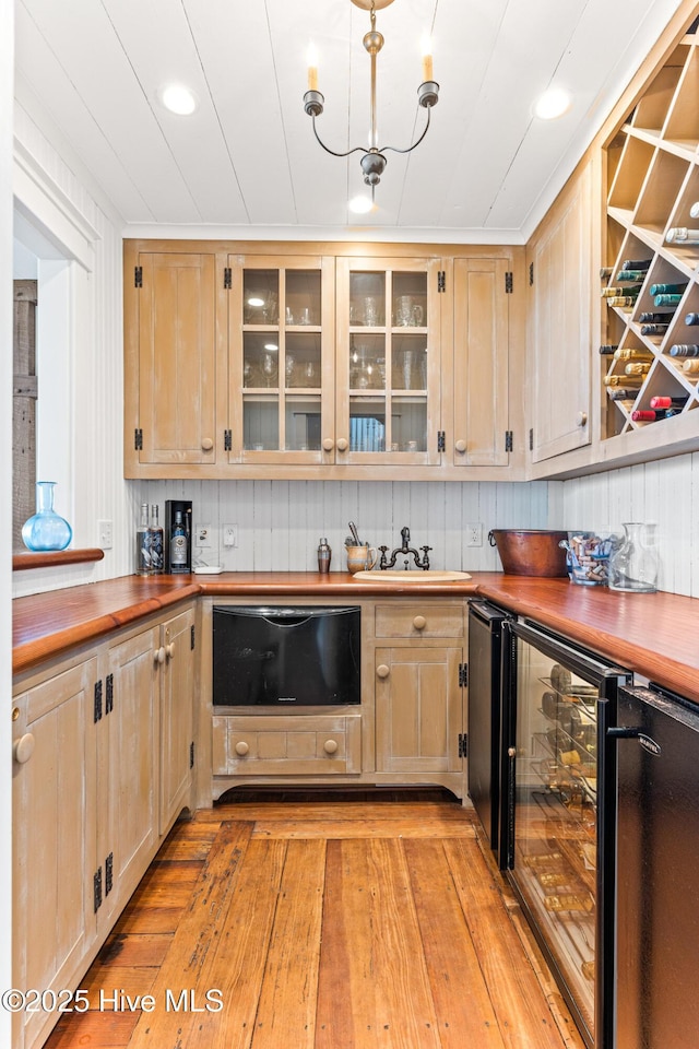 21 Sea Gull Trl, Bald Head Island, NC 28461 - kitchen featuring beverage cooler, light brown cabinets, light wood finished floors, glass insert cabinets, and butcher block countertops