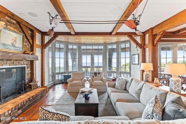 21 Sea Gull Trl, Bald Head Island, NC 28461 - living area featuring hardwood / wood-style floors, beam ceiling, french doors, and a brick fireplace
