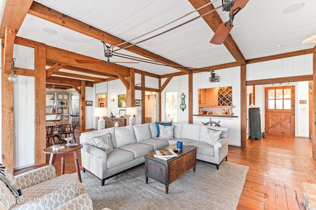 21 Sea Gull Trl, Bald Head Island, NC 28461 - living area featuring beam ceiling, light wood-style floors, and wood walls