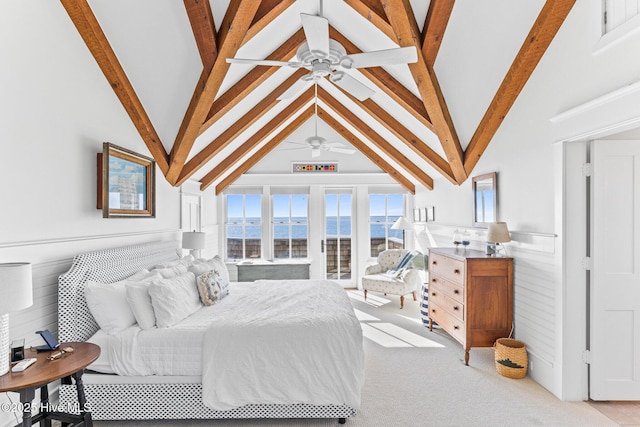 21 Sea Gull Trl, Bald Head Island, NC 28461 - bedroom with beam ceiling, light carpet, a water view, high vaulted ceiling, and a wainscoted wall