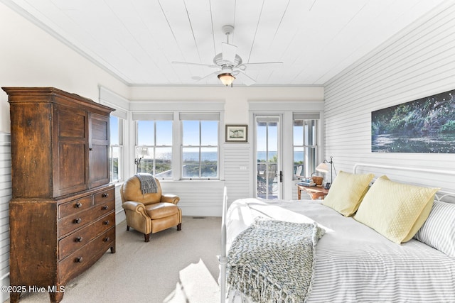 21 Sea Gull Trl, Bald Head Island, NC 28461 - bedroom with light colored carpet, access to outside, wooden walls, ceiling fan, and ornamental molding