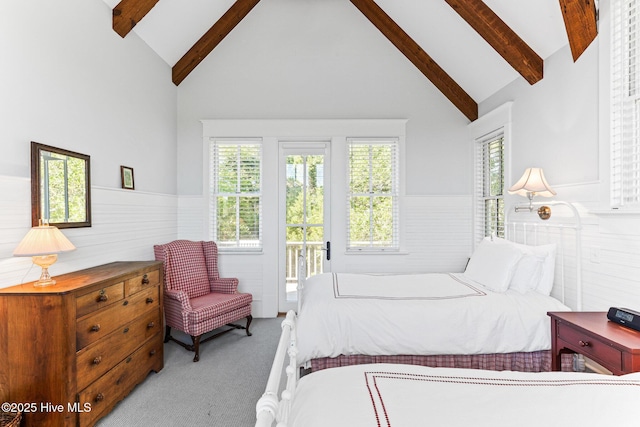 21 Sea Gull Trl, Bald Head Island, NC 28461 - carpeted bedroom featuring beam ceiling, wainscoting, high vaulted ceiling, and access to outside