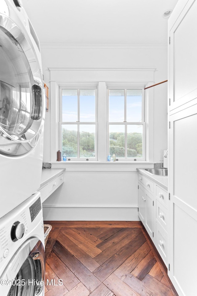 21 Sea Gull Trl, Bald Head Island, NC 28461 - washroom featuring estacked washer and dryer, cabinet space, and ornamental molding