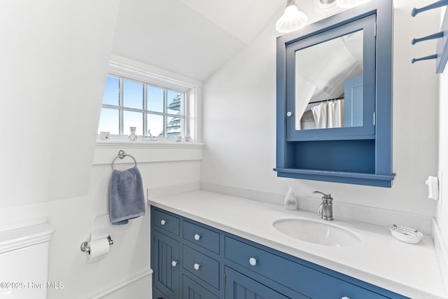 21 Sea Gull Trl, Bald Head Island, NC 28461 - bathroom featuring vanity, toilet, and vaulted ceiling