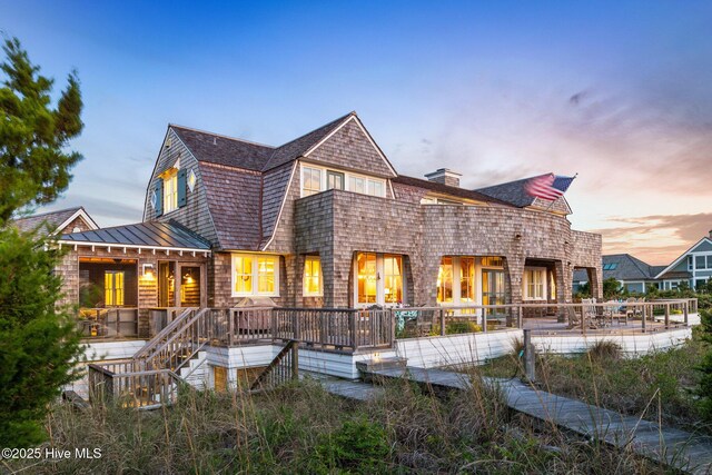 21 Sea Gull Trl, Bald Head Island, NC 28461 - back of property with a standing seam roof, metal roof, a deck, a chimney, and roof with shingles