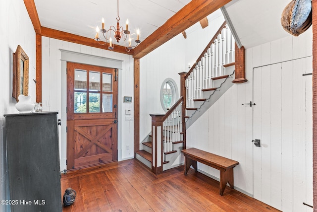 21 Sea Gull Trl, Bald Head Island, NC 28461 - foyer with hardwood / wood-style flooring, a chandelier, healthy amount of natural light, beam ceiling, and wood walls