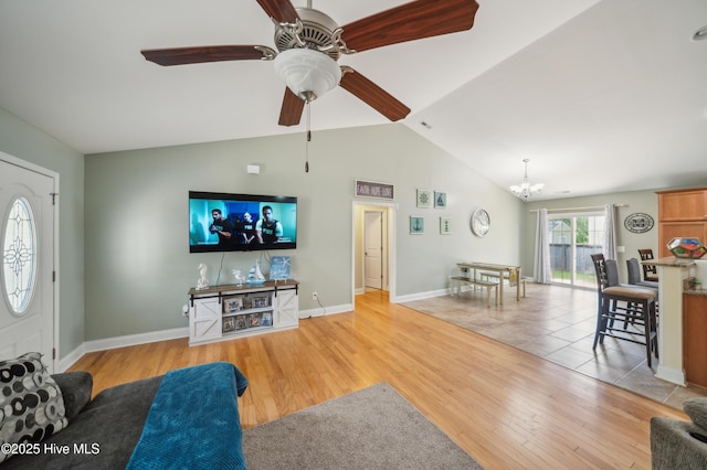 239 Shellbank Dr, Sneads Ferry, NC 28460 - living area with a chandelier, light wood-style floors, vaulted ceiling, ceiling fan, and baseboards