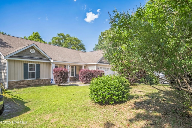 239 Shellbank Dr, Sneads Ferry, NC 28460 - view of front facade with stone siding, a front lawn, and an attached garage