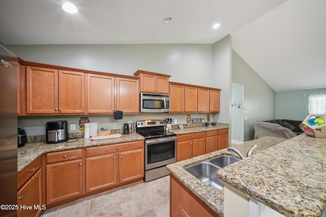 239 Shellbank Dr, Sneads Ferry, NC 28460 - kitchen featuring stainless steel appliances, a sink, high vaulted ceiling, open floor plan, and brown cabinetry