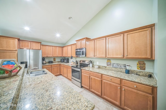 239 Shellbank Dr, Sneads Ferry, NC 28460 - kitchen with stainless steel appliances, a sink, vaulted ceiling, light stone counters, and recessed lighting