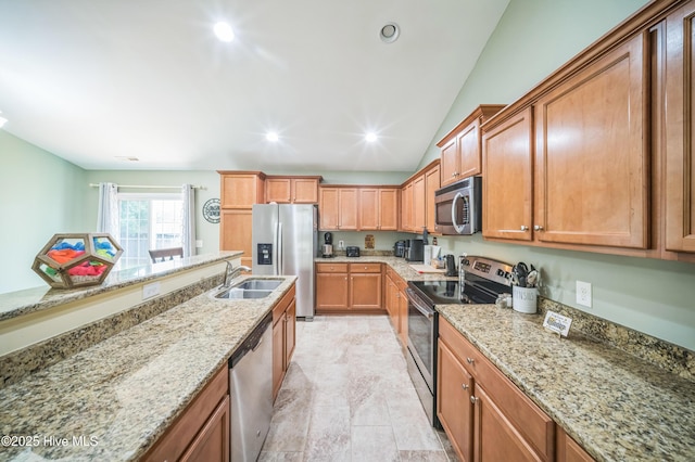 239 Shellbank Dr, Sneads Ferry, NC 28460 - kitchen featuring stainless steel appliances, a sink, light stone counters, lofted ceiling, and brown cabinets