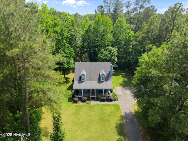 view of subject property with a forest