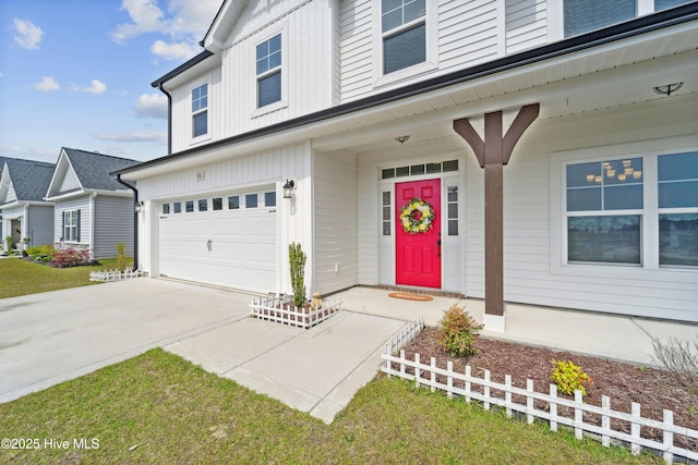 property entrance featuring a garage and driveway