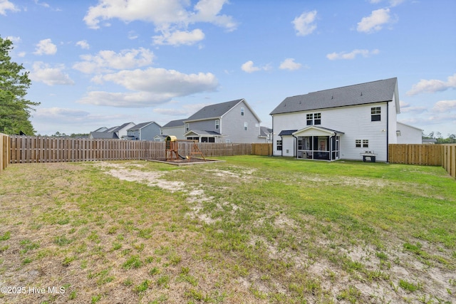 view of yard featuring a playground, a sunroom, and a residential view