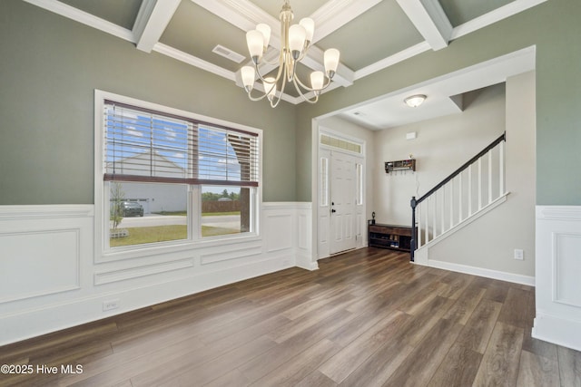 entryway with a chandelier, stairway, wainscoting, beam ceiling, and wood finished floors