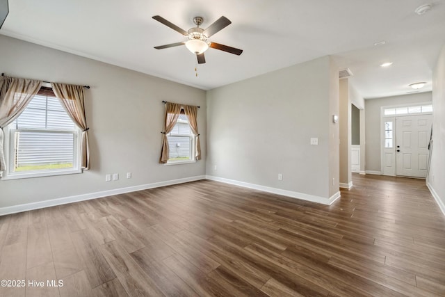 spare room with ceiling fan, dark wood finished floors, a smoke detector, and baseboards