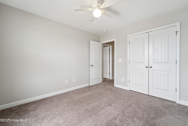 unfurnished bedroom with carpet, baseboards, a closet, and a ceiling fan