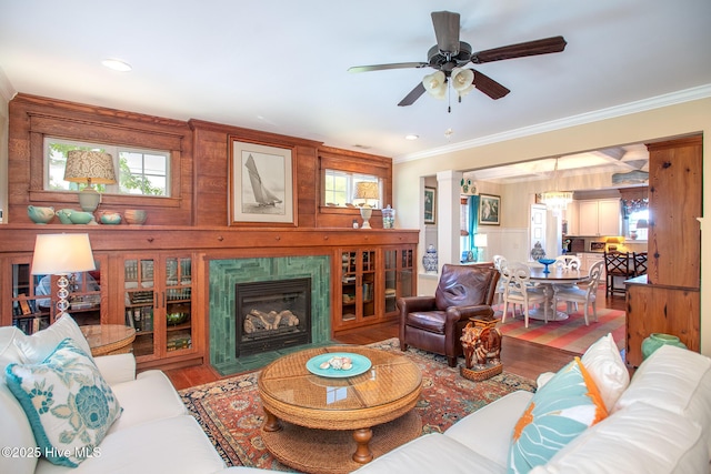 301 Hedrick St, Beaufort, NC 28516 - living area with wood finished floors, ornamental molding, ceiling fan, and a fireplace
