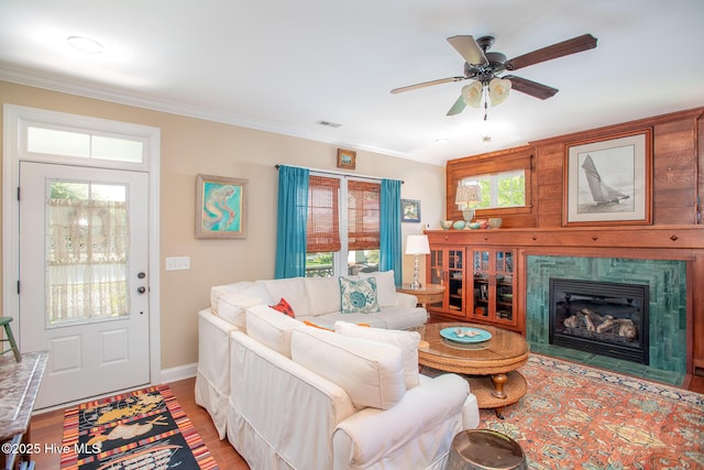 301 Hedrick St, Beaufort, NC 28516 - living area with wood finished floors, ceiling fan, crown molding, a high end fireplace, and baseboards