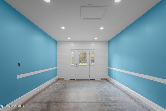 spare room featuring recessed lighting, unfinished concrete flooring, and baseboards